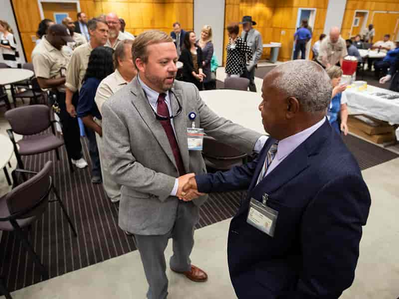 Construction Project Manager Bryan Walker offers well wishes to Ivory Bogan during Bogan's retirement reception.